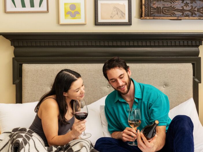man and woman reading a bottle label